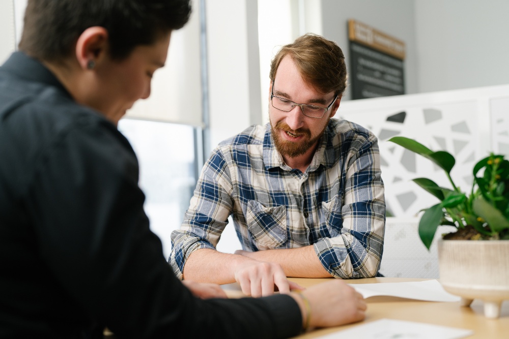 Two people reviewing paperwork at a desk