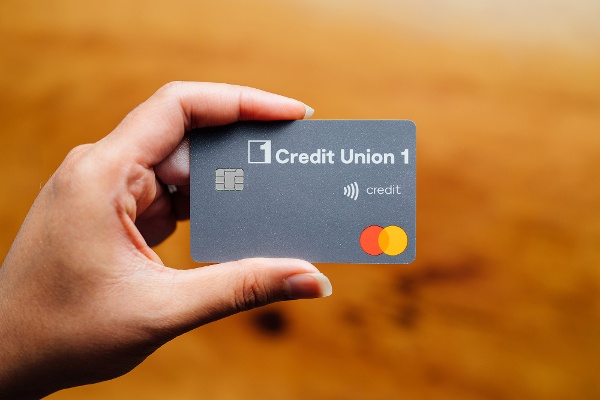 Hands holidng a CU1 credit card