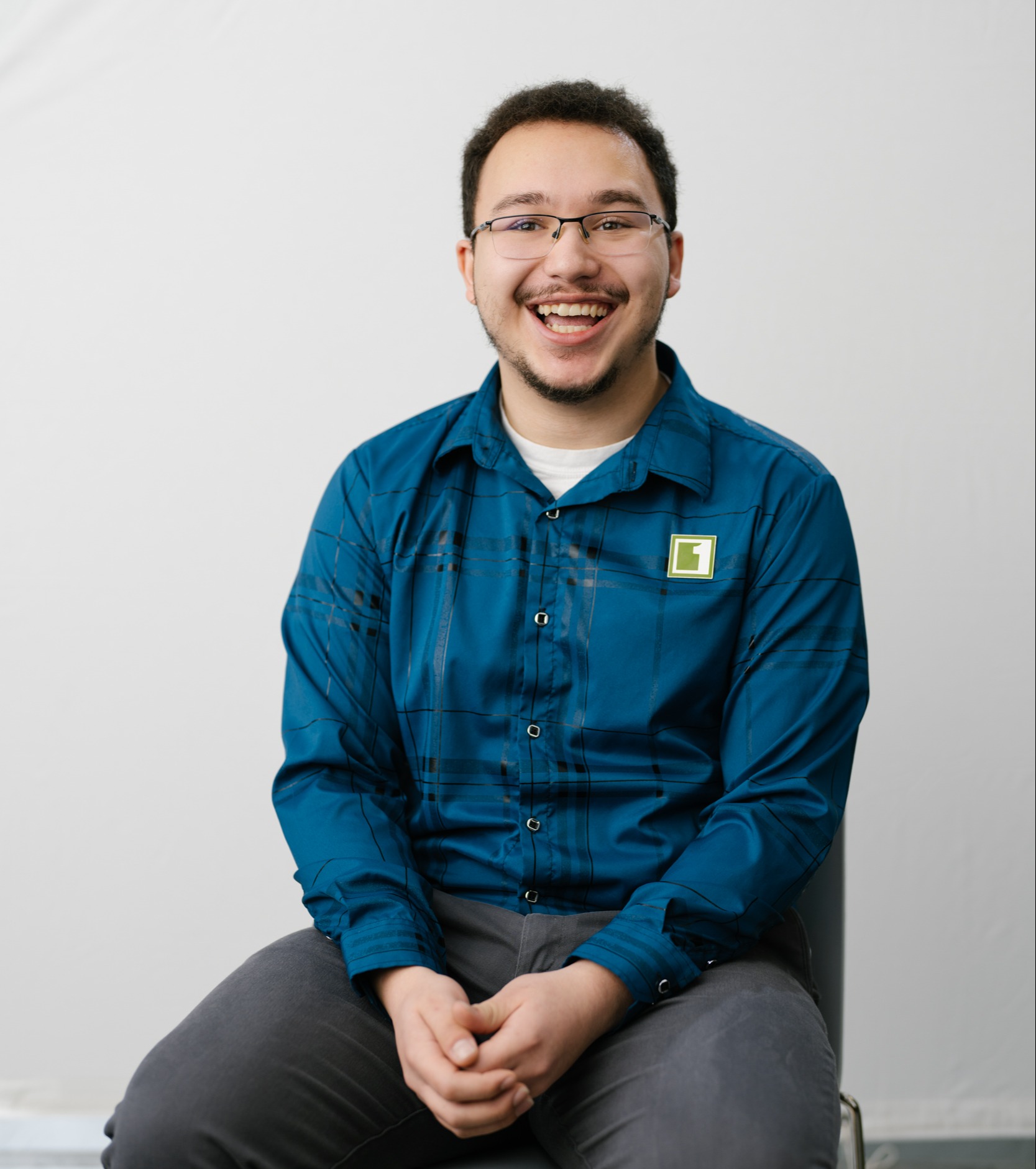 Man sitting on a chair smiling at camera