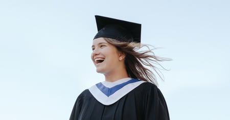 Woman in a cap and gown smiling