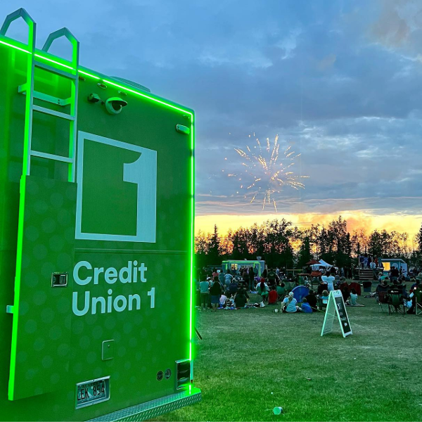CU1 Mobile Branch lit up with people and fireworks behind it.